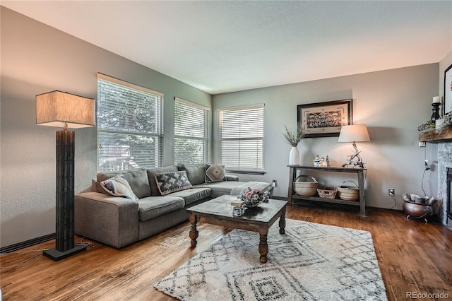 living room with hardwood / wood-style floors and a tile fireplace