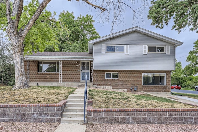 tri-level home with a front yard