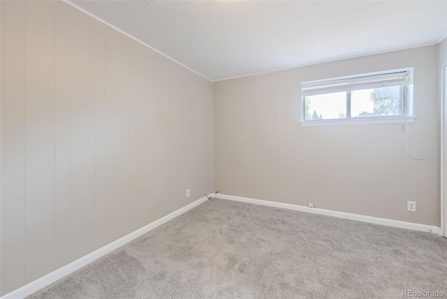 spare room featuring light colored carpet