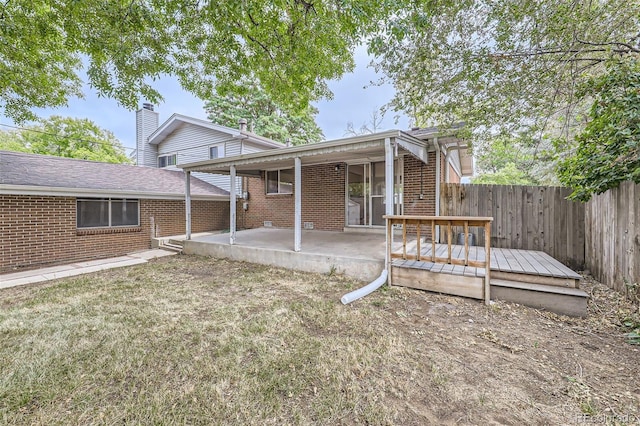 rear view of house featuring a patio area and a deck