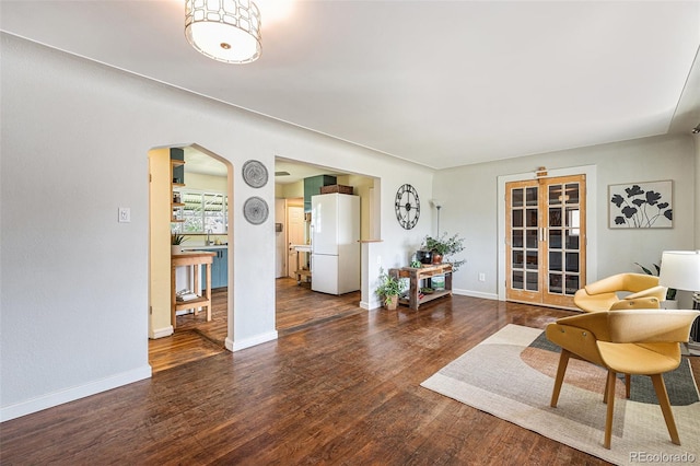 1666 S Bryant St, Denver, CO 80219 - living room with arched walkways, wood finished floors, and baseboards