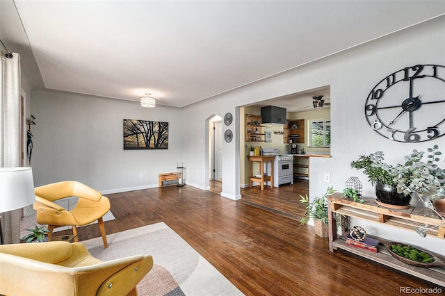 1666 S Bryant St, Denver, CO 80219 - living area featuring arched walkways, wood finished floors, and baseboards