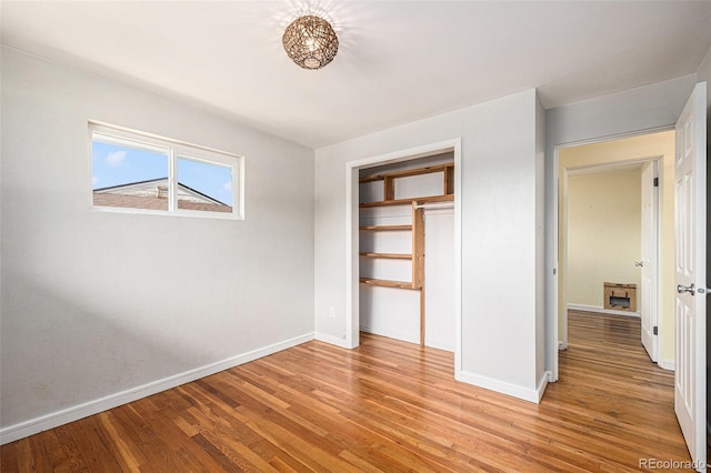 1666 S Bryant St, Denver, CO 80219 - unfurnished bedroom featuring baseboards, light wood-style floors, and a closet