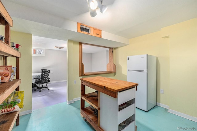1666 S Bryant St, Denver, CO 80219 - kitchen featuring freestanding refrigerator, butcher block counters, baseboards, and finished concrete flooring