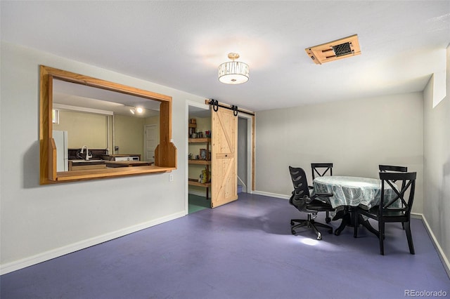 1666 S Bryant St, Denver, CO 80219 - dining room with a barn door, baseboards, and concrete flooring