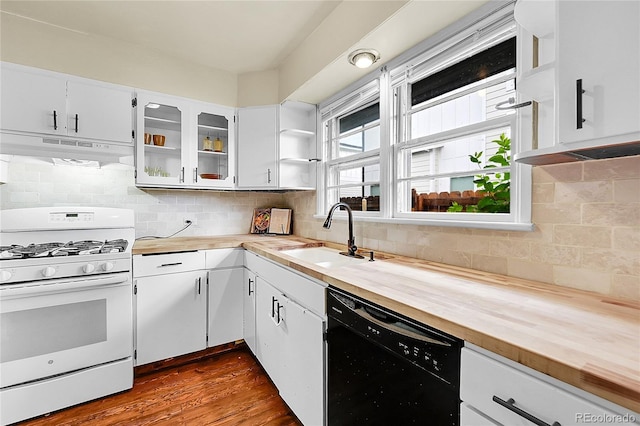 kitchen with white gas range, dishwasher, a sink, under cabinet range hood, and butcher block countertops