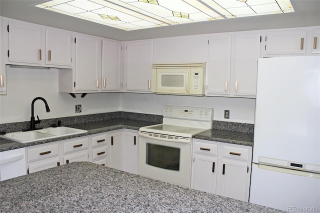 13952 E Marina Dr Unit 304, Aurora, CO 80014 - kitchen featuring white appliances, a sink, white cabinets, and dark stone countertops