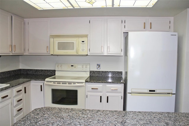 13952 E Marina Dr Unit 304, Aurora, CO 80014 - kitchen featuring white appliances, white cabinetry, and dark stone counters