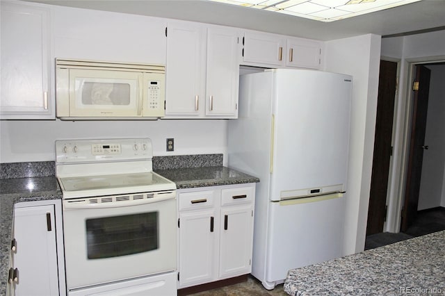 13952 E Marina Dr Unit 304, Aurora, CO 80014 - kitchen featuring white appliances, white cabinetry, and dark stone countertops