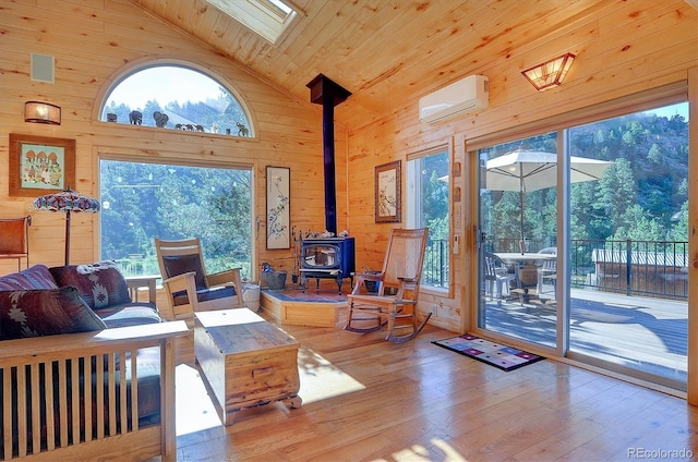 living room with a wood stove, high vaulted ceiling, an AC wall unit, wood ceiling, and light wood-type flooring