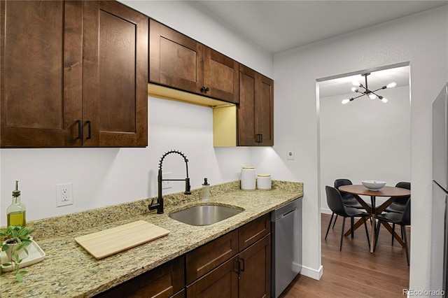7995 E Mississippi Ave Unit K3, Denver, CO 80247 - kitchen with stainless steel dishwasher, wood finished floors, dark brown cabinets, a chandelier, and light stone countertops