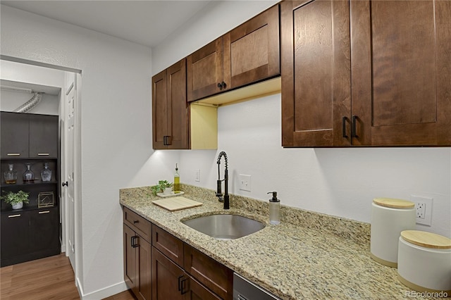 7995 E Mississippi Ave Unit K3, Denver, CO 80247 - kitchen featuring wood finished floors, light stone countertops, and dark brown cabinetry