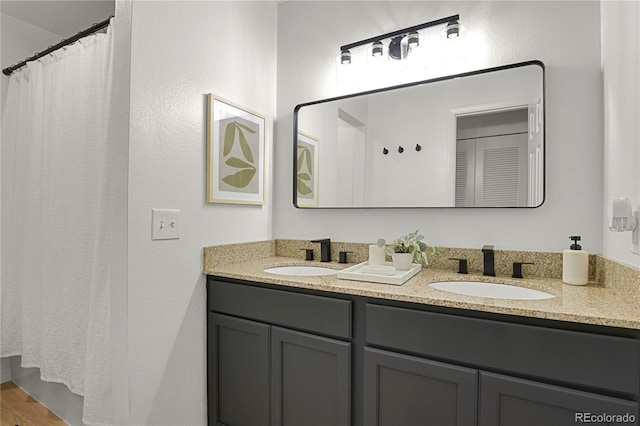 7995 E Mississippi Ave Unit K3, Denver, CO 80247 - bathroom with double vanity, a shower with shower curtain, and wood finished floors
