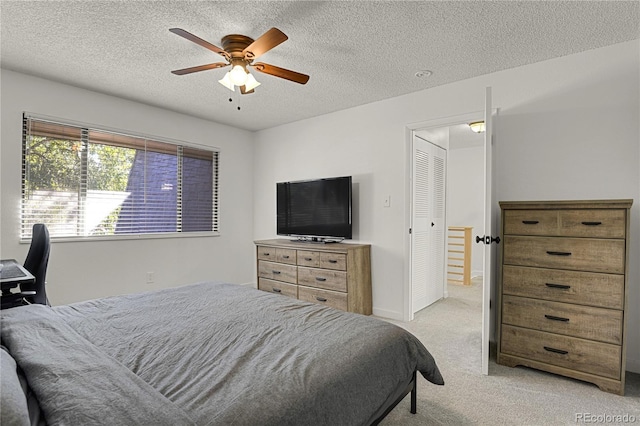 7995 E Mississippi Ave Unit K3, Denver, CO 80247 - bedroom featuring light carpet, a textured ceiling, and a ceiling fan