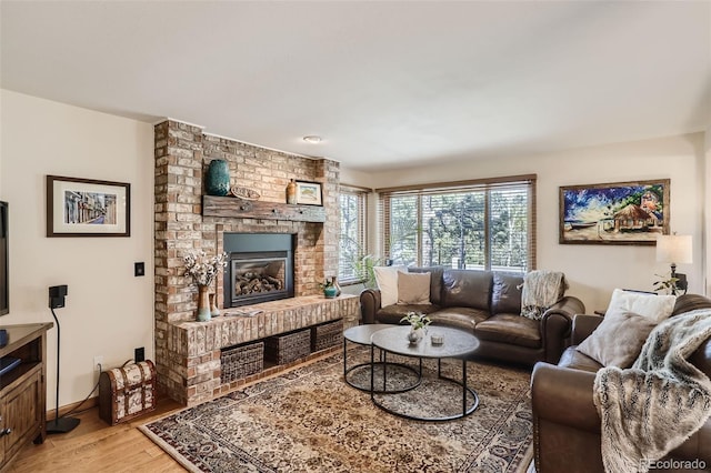 living area with a fireplace and light wood-style flooring