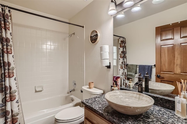 full bathroom with toilet, shower / tub combo with curtain, and vanity