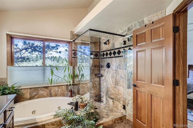 full bath featuring a tub with jets, a shower stall, and vanity