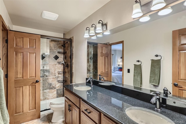 ensuite bathroom featuring connected bathroom, a stall shower, a sink, and toilet