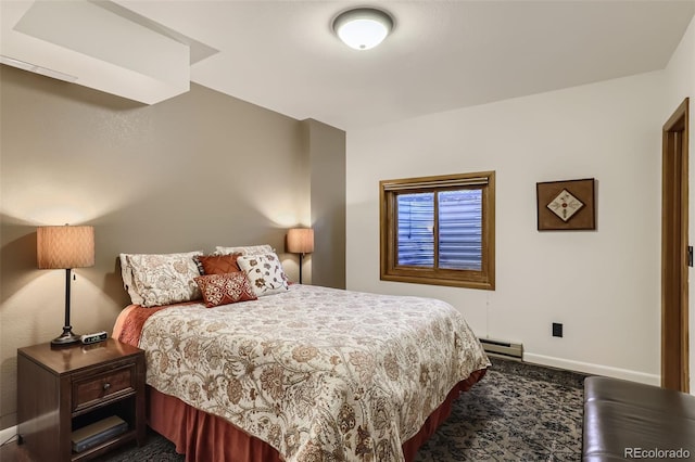 bedroom featuring a baseboard heating unit and baseboards