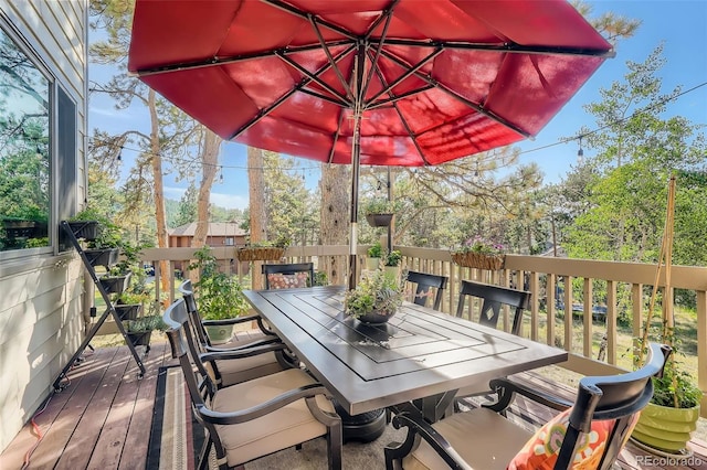 wooden terrace with outdoor dining space