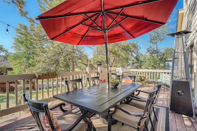 wooden deck with outdoor dining area and area for grilling