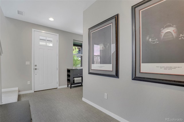 foyer entrance featuring carpet flooring, recessed lighting, baseboards, and visible vents