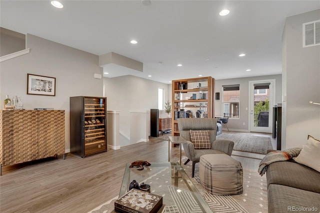 living area featuring recessed lighting, baseboards, visible vents, and wood finished floors