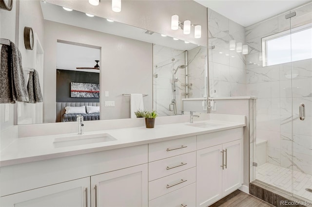 full bathroom with double vanity, a sink, ensuite bath, and a shower stall