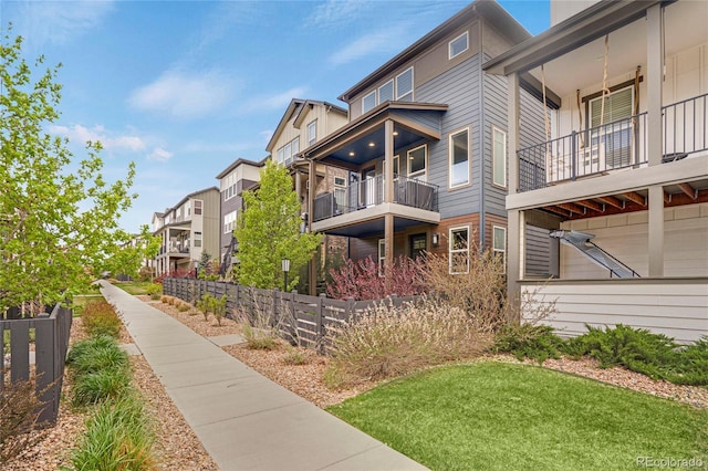 view of home's community featuring fence