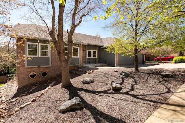 6668 Fairways Dr, Longmont, CO 80503 - single story home with driveway, brick siding, and a garage