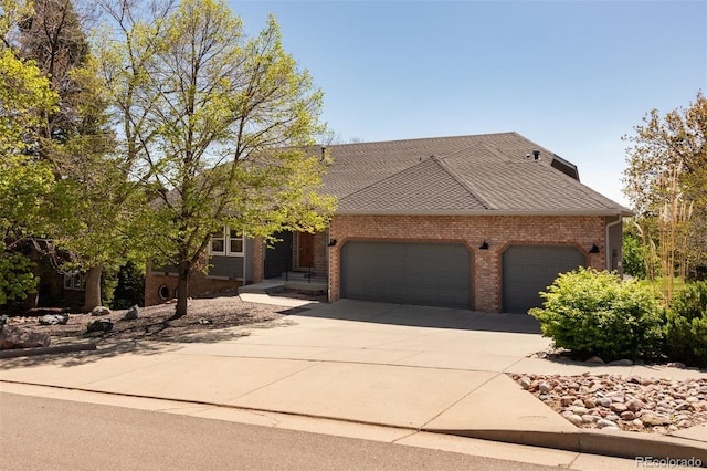 6668 Fairways Dr, Longmont, CO 80503 - view of front of property featuring an attached garage, concrete driveway, and brick siding