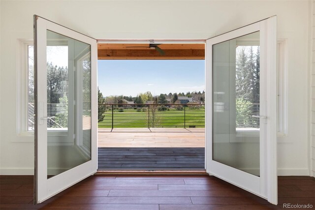 6668 Fairways Dr, Longmont, CO 80503 - doorway to outside with dark wood finished floors, plenty of natural light, and baseboards