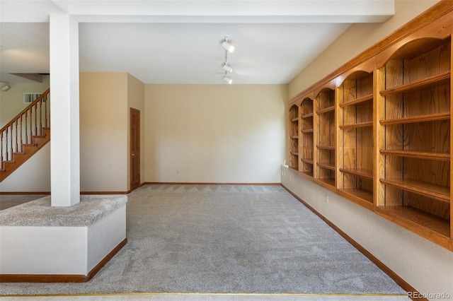 6668 Fairways Dr, Longmont, CO 80503 - empty room featuring carpet flooring, track lighting, stairs, and baseboards