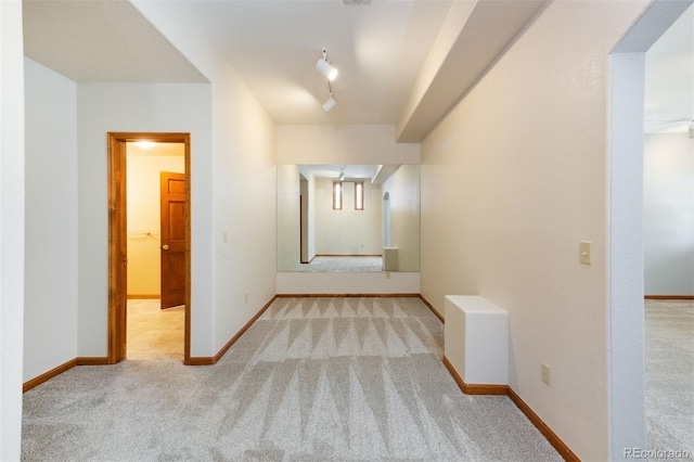 6668 Fairways Dr, Longmont, CO 80503 - hallway featuring carpet flooring, baseboards, and track lighting
