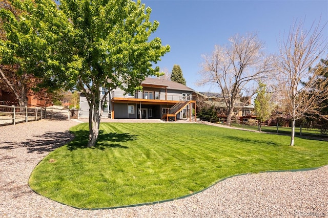 6668 Fairways Dr, Longmont, CO 80503 - view of yard featuring stairway and a wooden deck