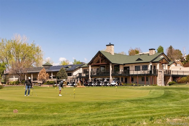 6668 Fairways Dr, Longmont, CO 80503 - surrounding community with a lawn, a putting green, and golf course view