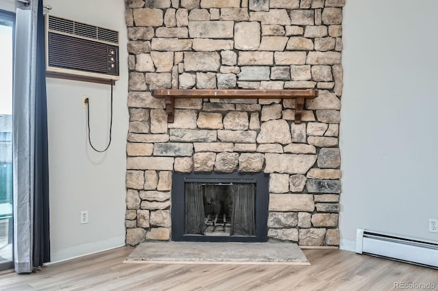 detailed view of a baseboard heating unit, baseboards, and wood finished floors