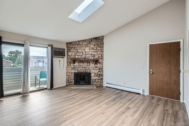 unfurnished living room with a baseboard radiator, a skylight, wood finished floors, a fireplace, and an AC wall unit