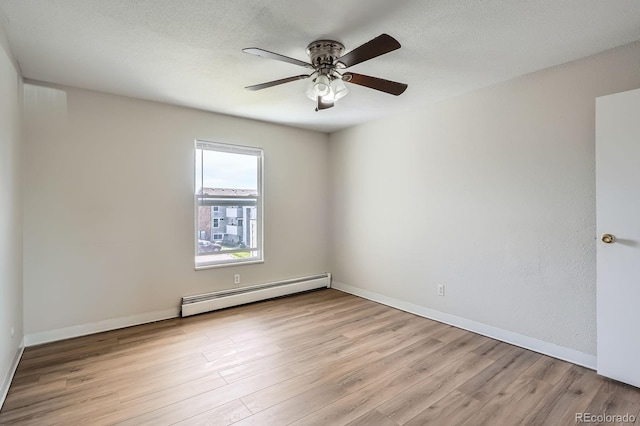 unfurnished room featuring a baseboard radiator, light wood-style floors, ceiling fan, and baseboards