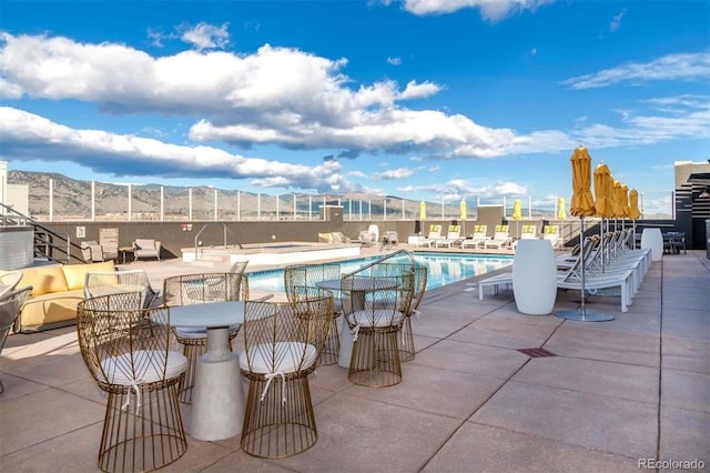 view of pool with a mountain view and a patio area