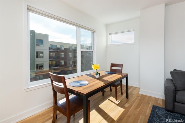 dining space with light hardwood / wood-style flooring