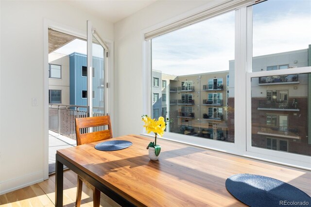 dining space with a healthy amount of sunlight and light hardwood / wood-style floors