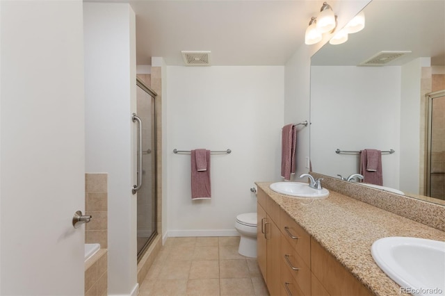 full bathroom featuring toilet, tile patterned floors, shower with separate bathtub, and vanity