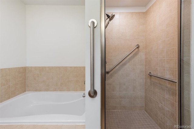 bathroom featuring separate shower and tub