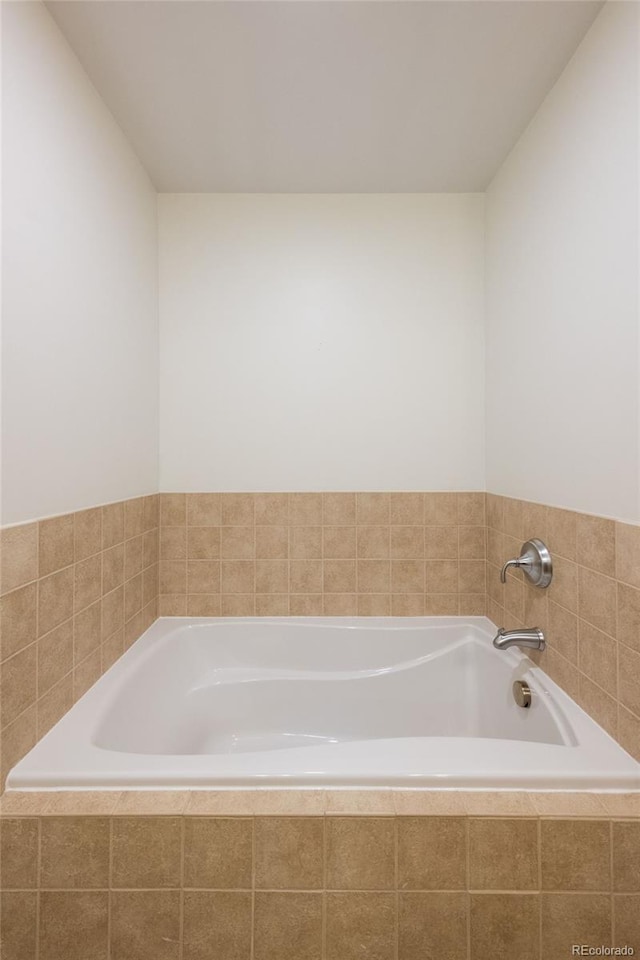 bathroom featuring tiled bath