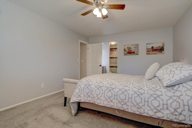 carpeted bedroom with a walk in closet and ceiling fan