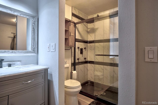 bathroom featuring vanity, toilet, and walk in shower