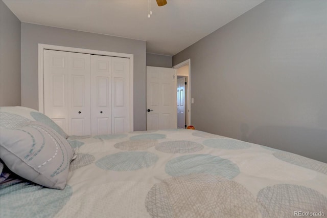 bedroom featuring ceiling fan and a closet