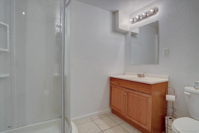 bathroom featuring tile patterned flooring, vanity, toilet, and a shower with door