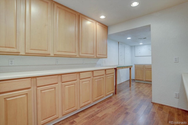 kitchen featuring light brown cabinetry and light hardwood / wood-style flooring